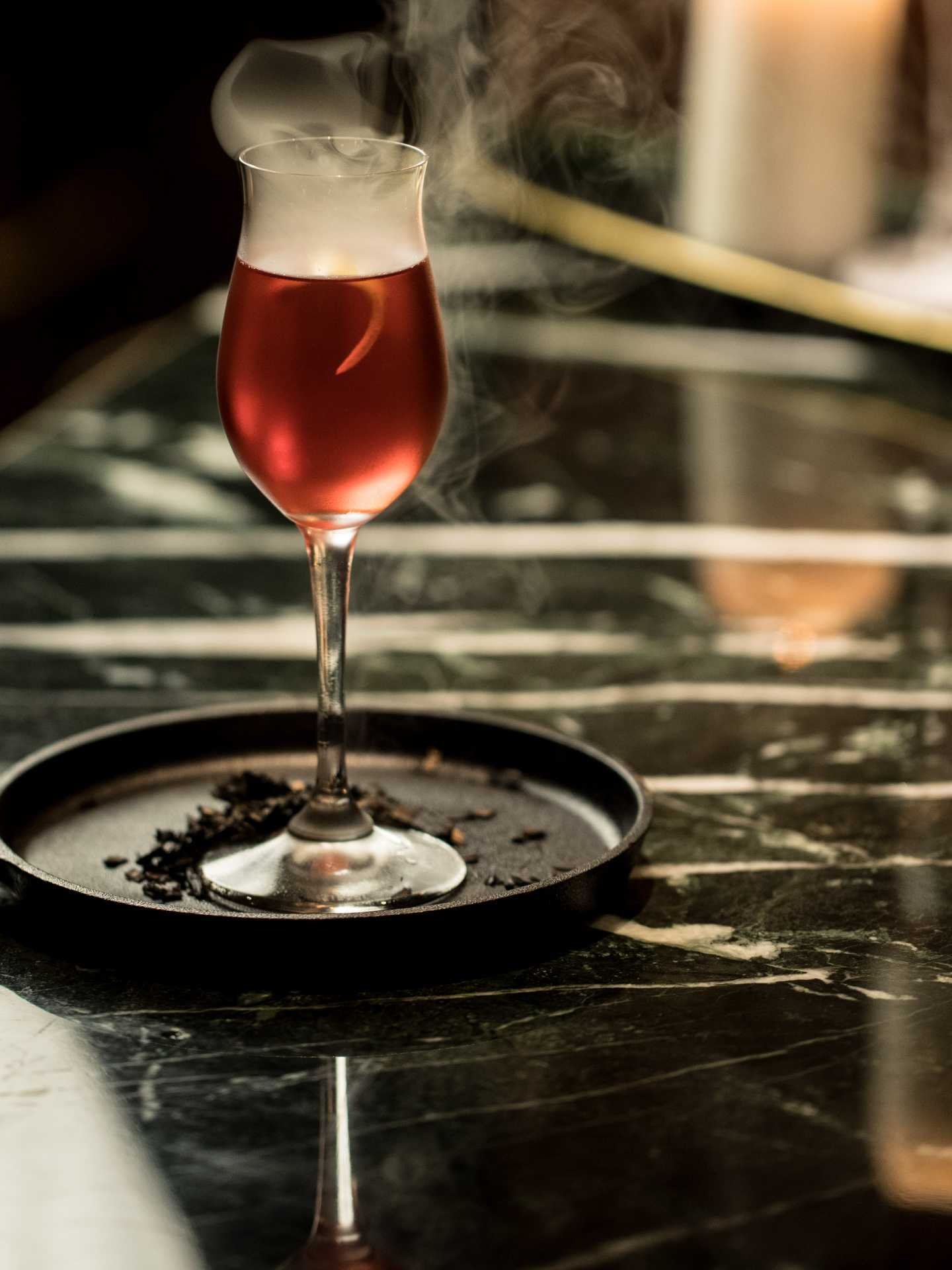 The best bars in Toronto | An smoking red cocktail at à toi in Coffee Oysters Champagne