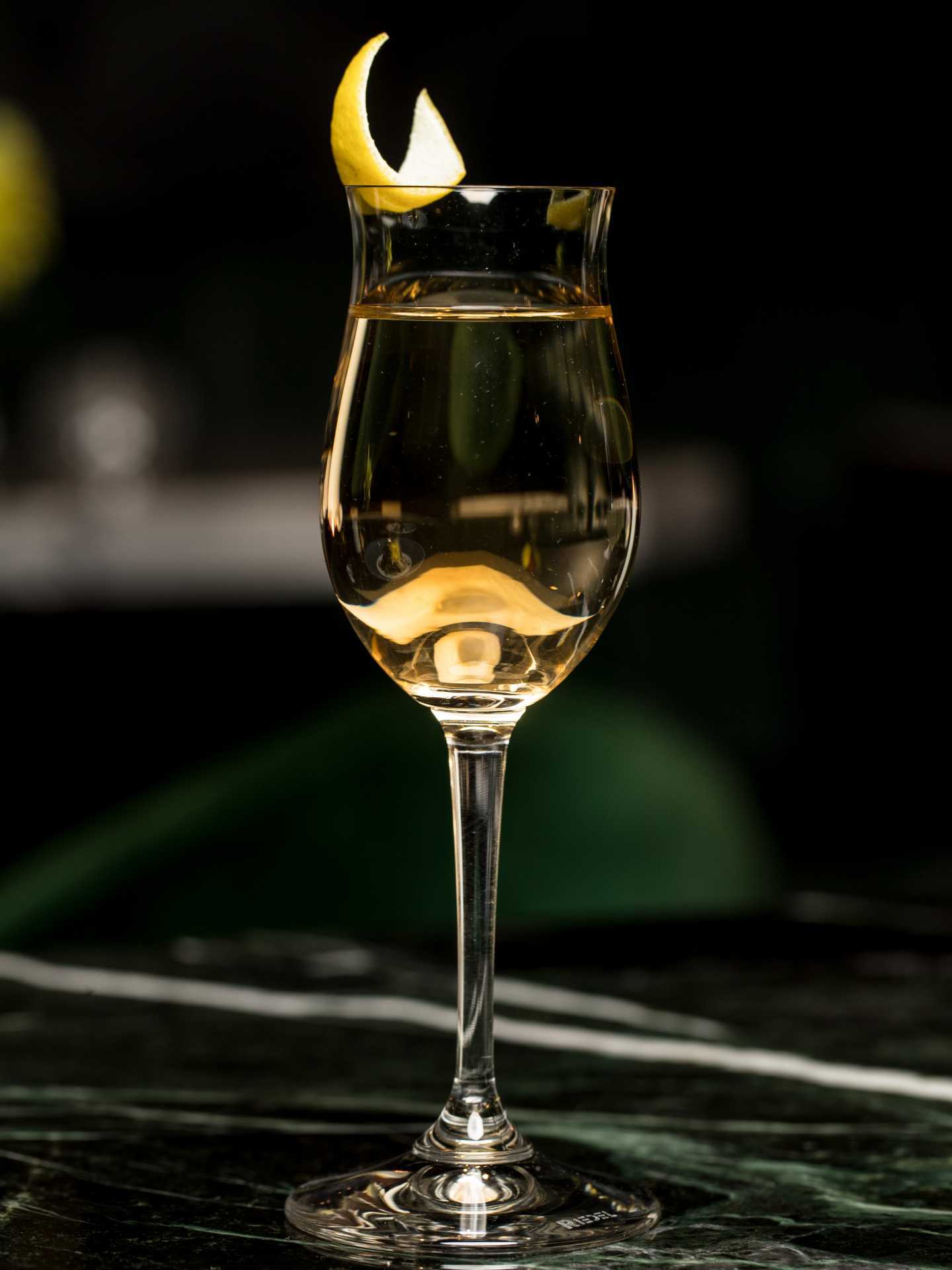 The best bars in Toronto | A clear cocktail garnished with citrus at à toi in Coffee Oysters Champagne