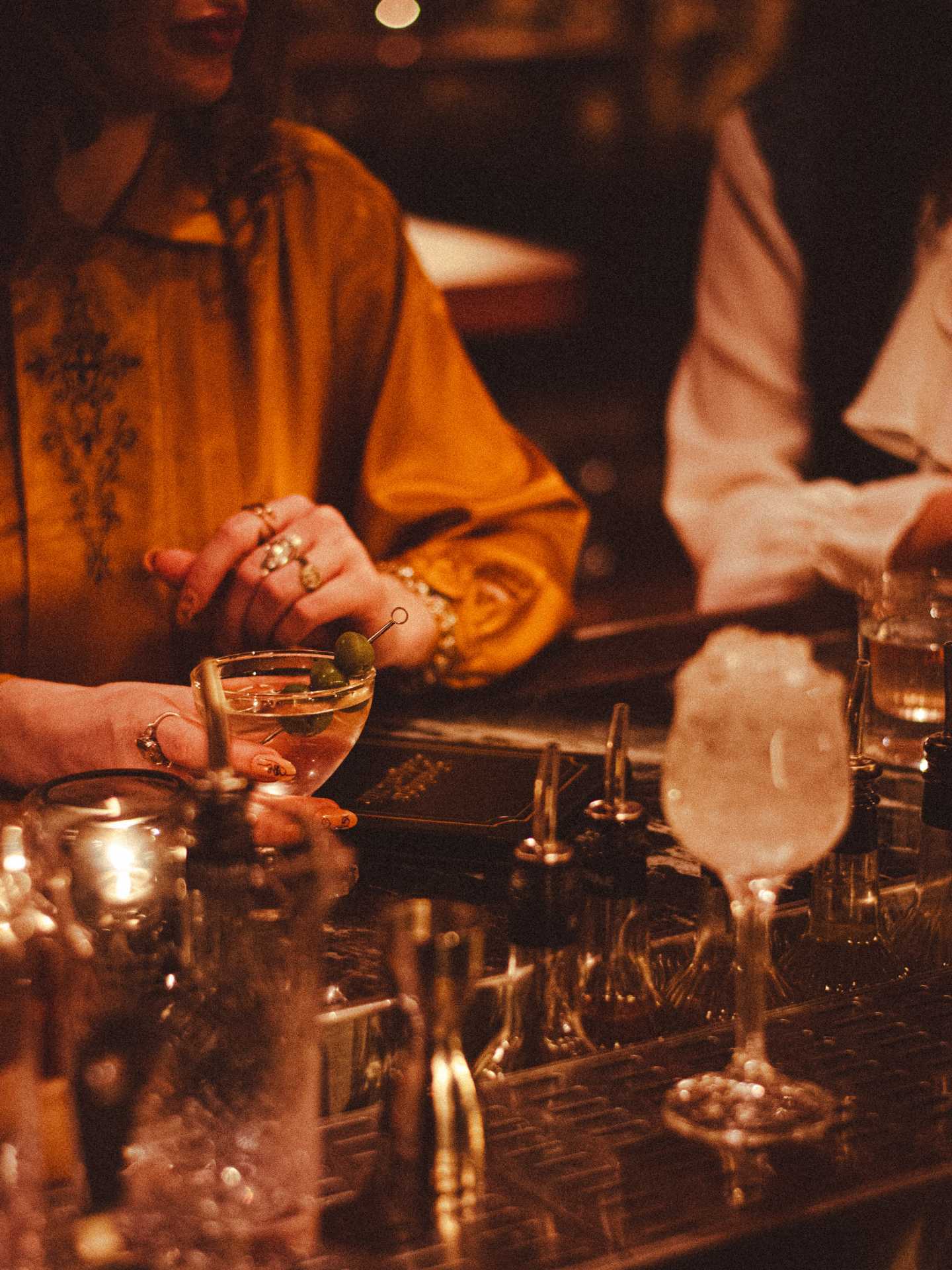 The best bars in Toronto | A guest enjoying a martini at Goodnight Cocktail Club