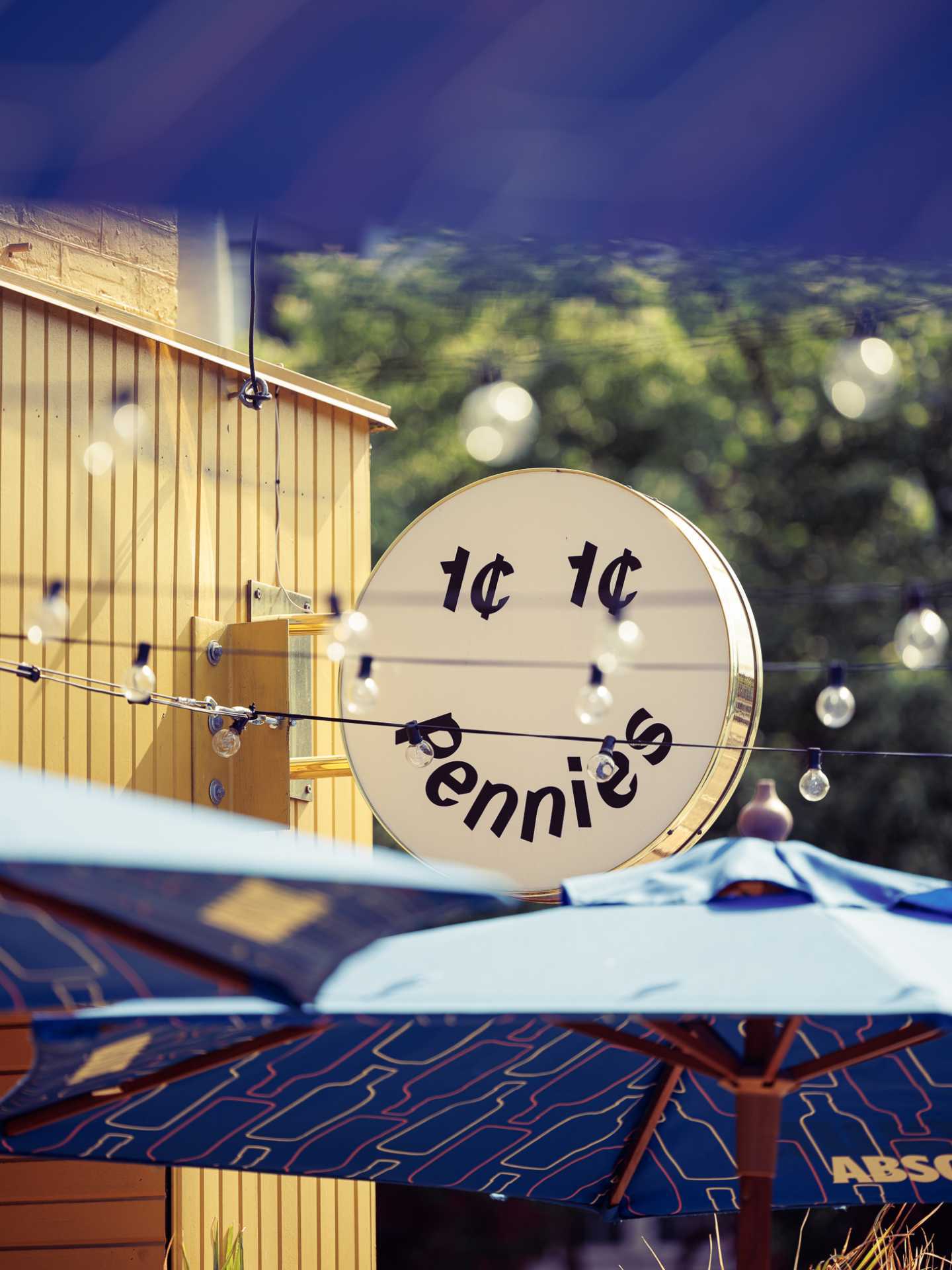 The best bars in Toronto | The logo and patio umbrellas at Pennies