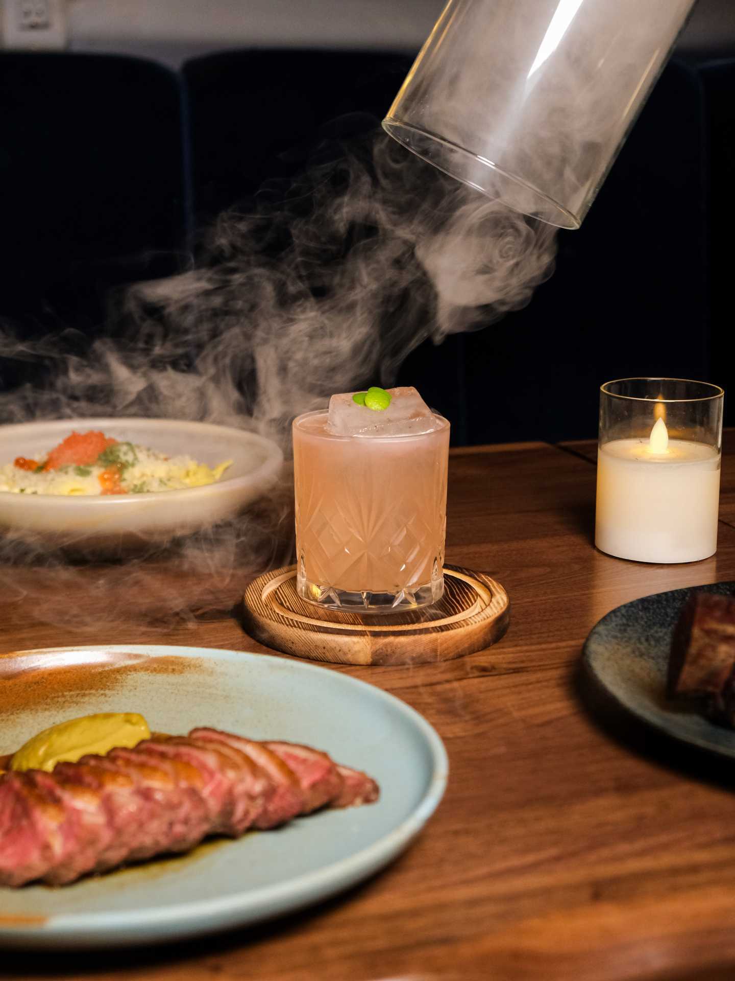 Best new restaurants Toronto | The Herby Berry cocktail being unveiled in a plume of smoke at Fallen Feather on Ossington