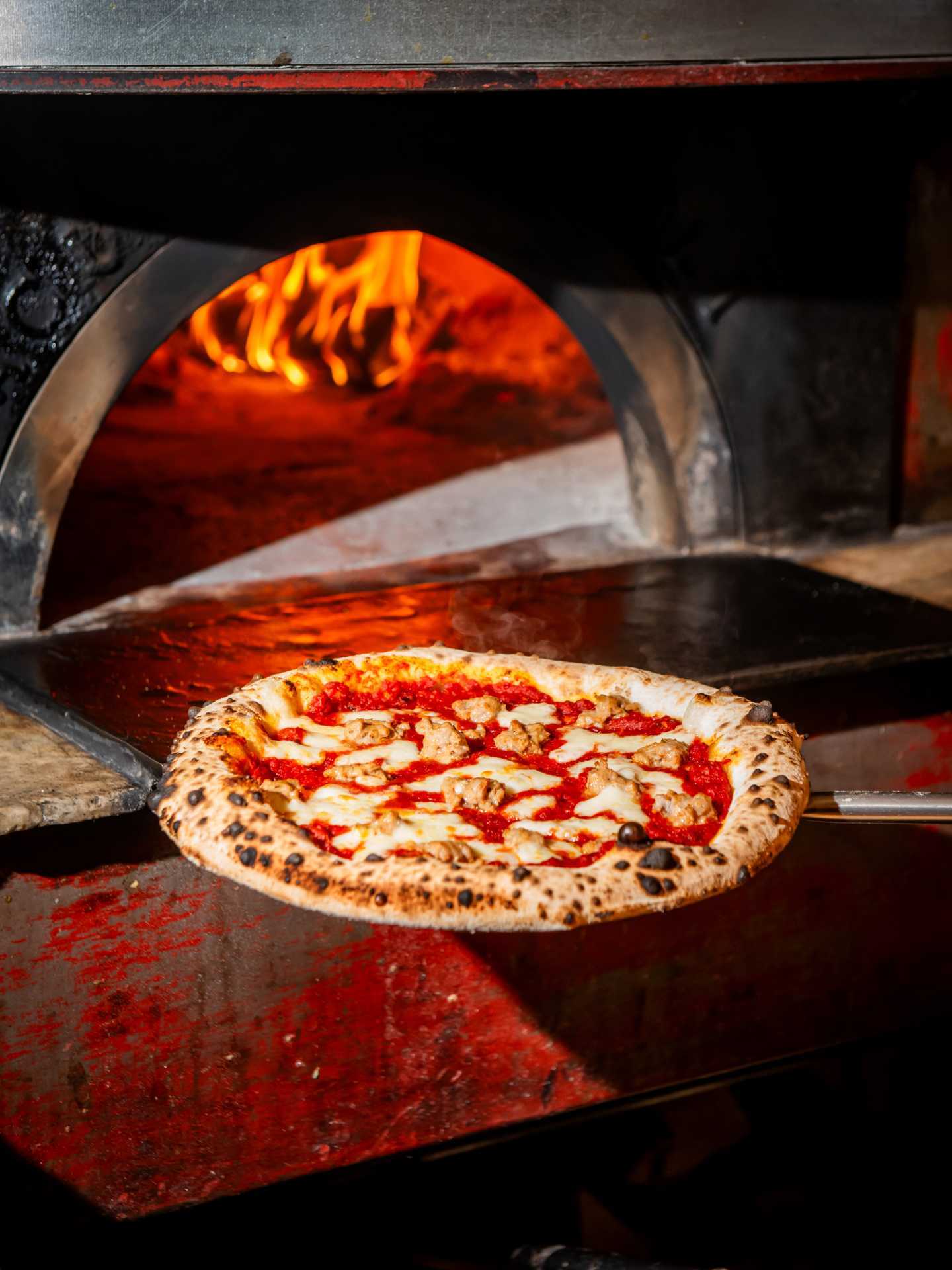 Toronto pizza | Taking a pizza out of the oven at Pizza e Pazzi
