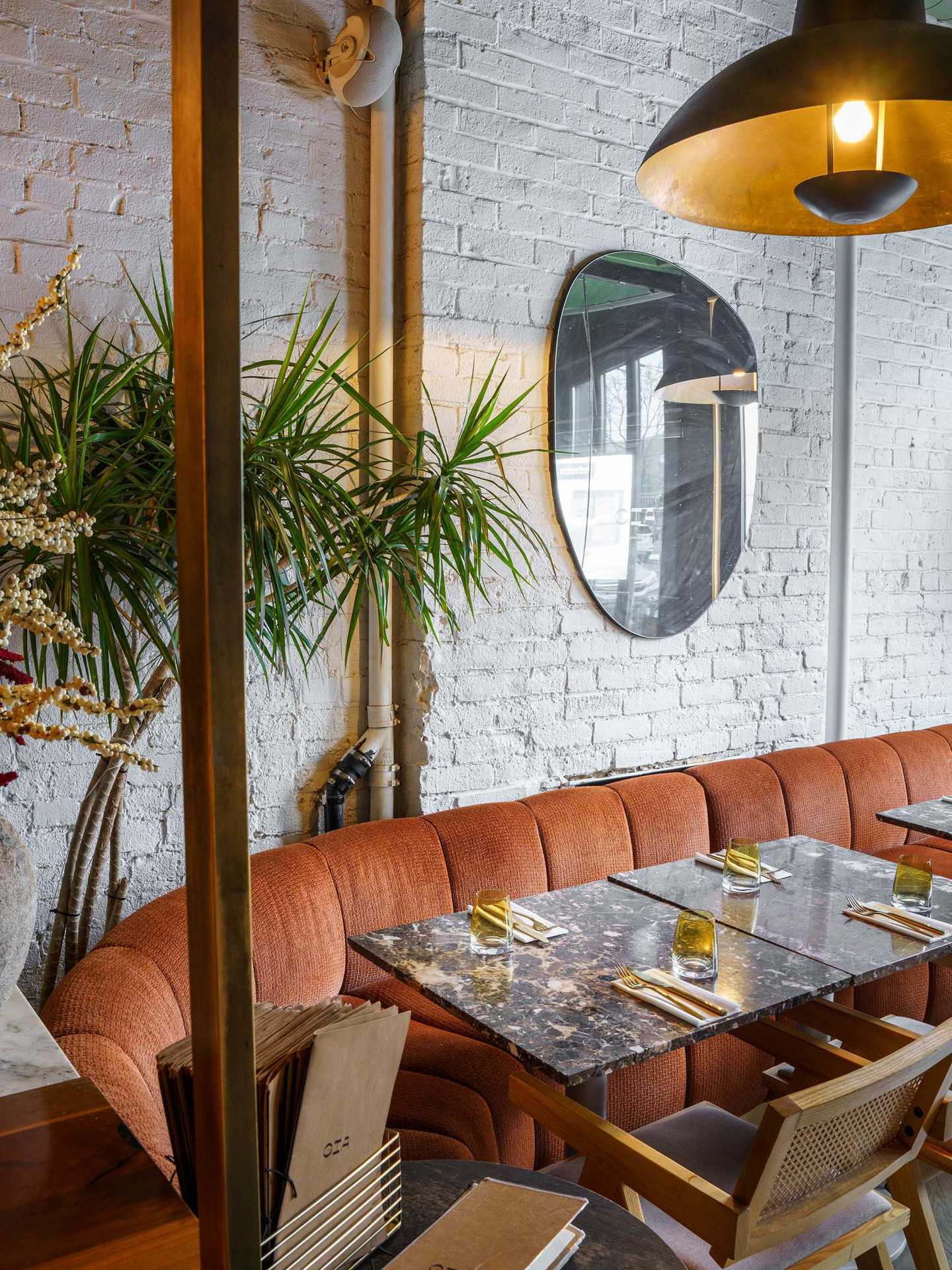 Queer-owned restaurants Toronto | A banquette inside Gia Restaurant