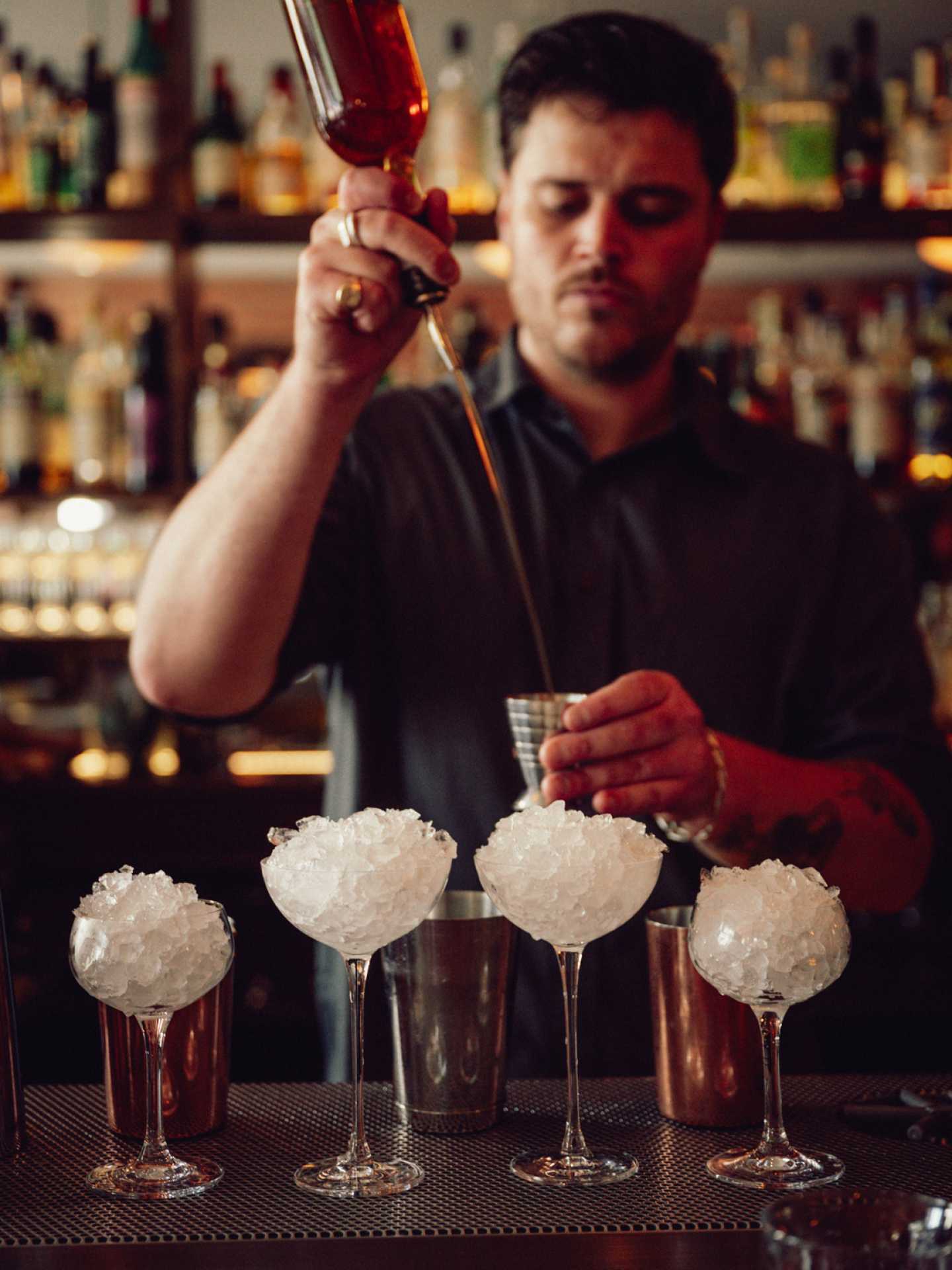 The best patios in Toronto | A bartender preps and pours cocktails at Contrada on College Street