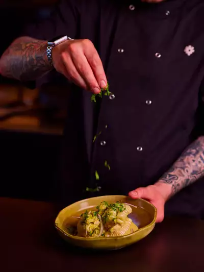 Best happy hours in Toronto | A chef holding a plate of food