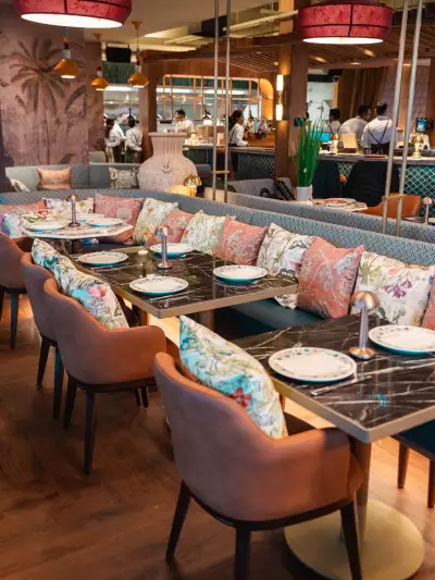 Best new Toronto restaurants | Pink floral pillows on a banquette inside Mishree
