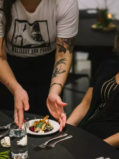 Indigenous food experiences in Canada | A server puts down a dish at A Taste of the Atlantic