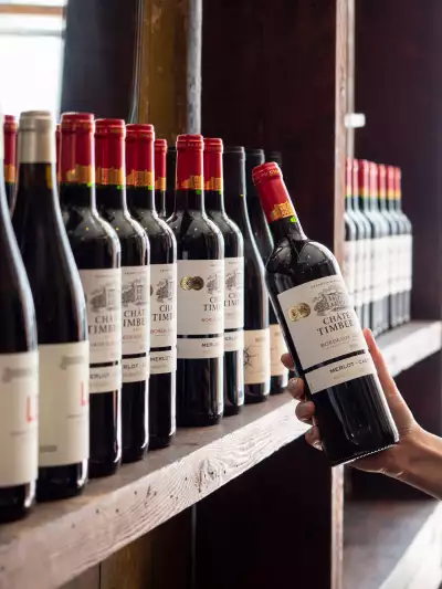 Best new Toronto restaurants | Pulling a wine bottle off the shelf at J's Steak Frites