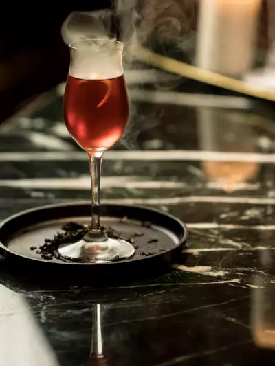 The best bars in Toronto | An smoking red cocktail at &agrave; toi in Coffee Oysters Champagne