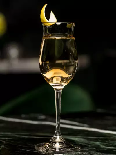 The best bars in Toronto | A clear cocktail garnished with citrus at &agrave; toi in Coffee Oysters Champagne