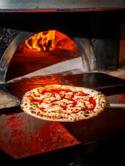 Toronto pizza | Taking a pizza out of the oven at Pizza e Pazzi