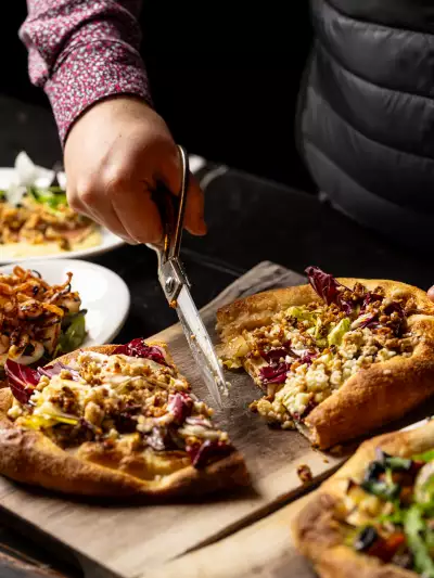 Best new Toronto restaurants | Cutting pizza at Notte Ristorante