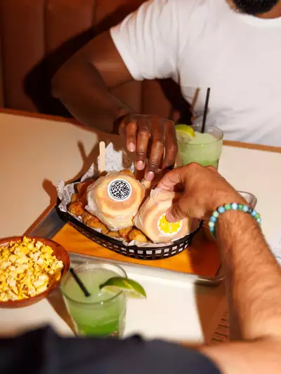 The best bars in Toronto | Guests grabbing sliders at Pennies on College