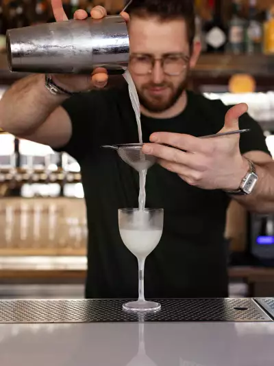 A bartender pouring a cocktail at Bar Allegro