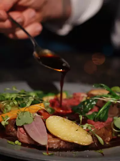 Best Ontario restaurants | Pouring jus over a meat dish at Spencer's at the Waterfront