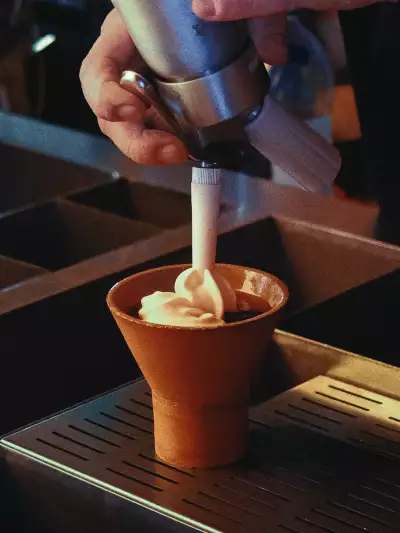 Best caf&eacute;s and coffee shops in Toronto | Adding whip to a drink at 915 Dupont