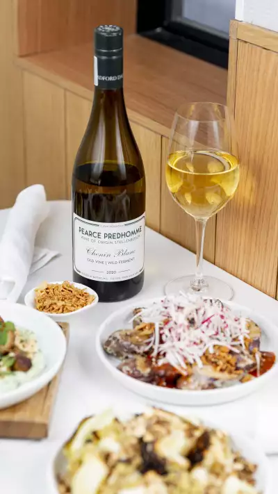 Sara wine pairing | A spread of wine and small plates at Sara