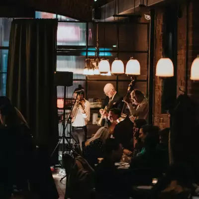Musicians on stage playing music at a bar