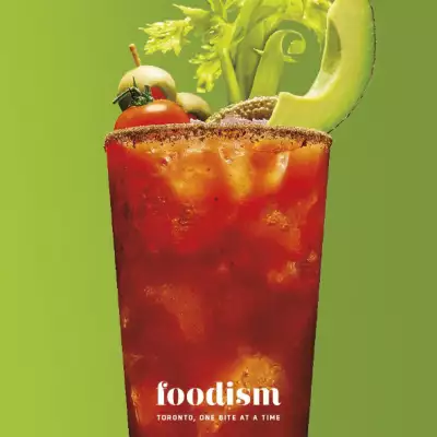 A large caesar cocktail over a green background