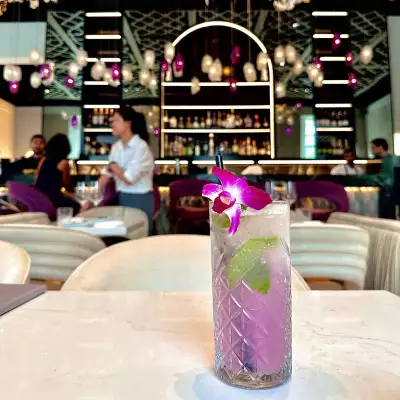 A purple cocktail on a table in Laylak restaurant