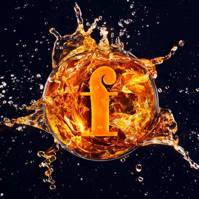 The Foodism F in a glass of orange liquid