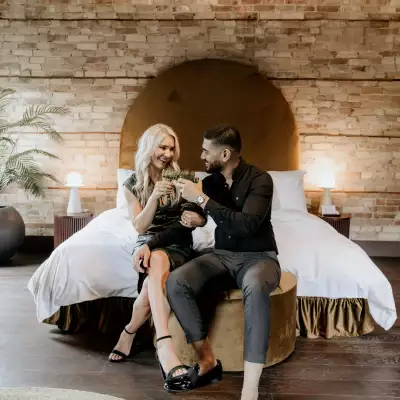 Foodie gift ideas | A couple sitting on a bed at Hotel Julie
