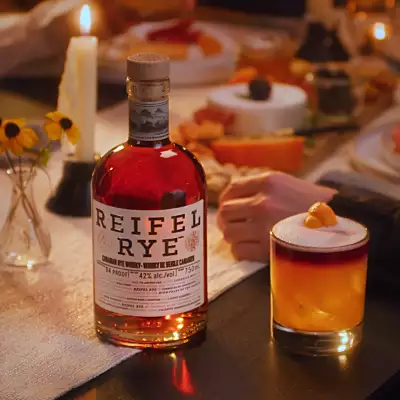 Holiday bottles to gift | Reifel Rye with a cocktail on the dinner table