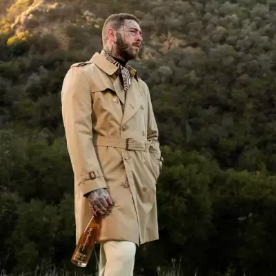 Post Malone holding a bottle of wine