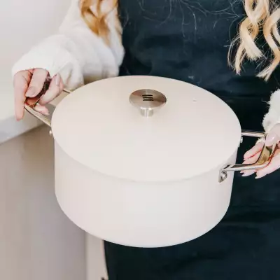 A home cook holding the Kilne Everything Pot