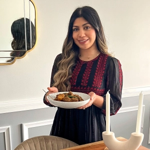 Ontario veal | Fariha Ekra holding her veal curry and smiling at the camera Ontario veal | Fariha Ekra holding her veal curry and smiling at the camera