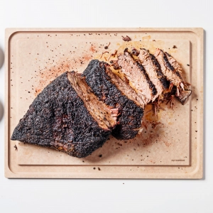 An Epicurean cutting board with a sliced roast An Epicurean cutting board with a sliced roast