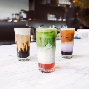 The best cafes in Toronto | An ube latte, strawberry matcha latte and iced mocha at 10 Dean