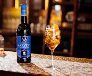 Harveys Bristol Cream Sherry | A bottle of Harveys Bristol Cream Sherry sits beside a cocktail