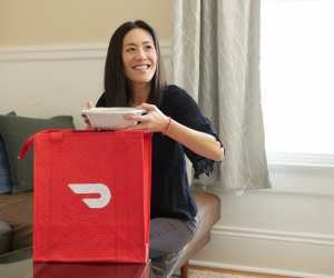 Neighbourhood Gems on DoorDash | A woman receives her DoorDash delivery at home