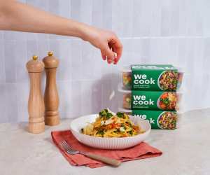 Sprinkling cheese onto a bowl of pasta from WeCook