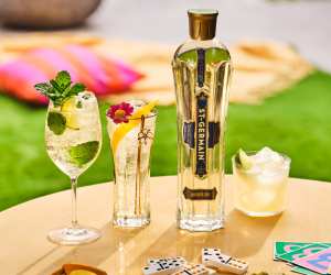 A bottle of St-Germain Elderflower Liqueur with three cocktails