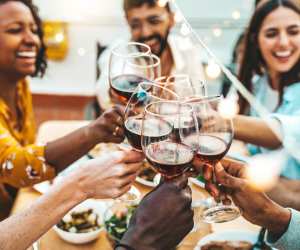 People cheers their wine at the Benchlands Blanc Party in Jordan Village
