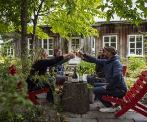 Four people enjoying glasses of wine at a beautiful Québec vineyard