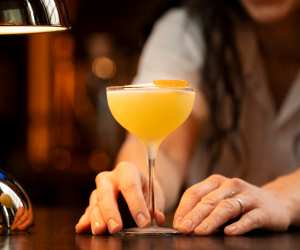 North Americas Best Bars Toronto | Civil Works bar manager Élise Hanson holds the Rag Trade cocktail from the Cutting Rug menu