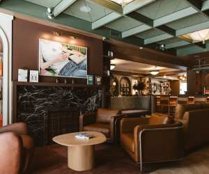 New Toronto restaurants | Comfy chairs and art on the wall at Book Bar Toronto