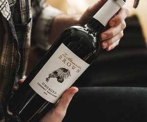 Hands holding a bottle of Z. Alexander Brown Uncaged Cabernet Sauvignon