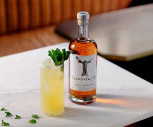 A bottle of Glendalough Double Barrel Irish Whiskey with a yellow cocktail