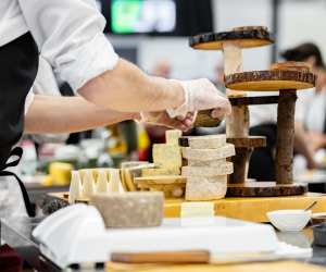 SIAL Canada | A cheesemaker displays their products at a booth at SIAL Canada