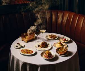 Punch Toronto | A shot of a table shot at Punch, featuring Beef Wellington, Scotch Egg and Mumbai Chat-Slaw