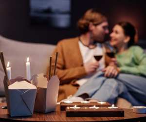 Toronto takeout and wine pairings | A couple with takeout boxes