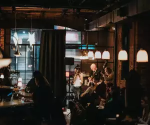 Restaurants and bars with live music in Toronto | Guests at the bar watch a small band playing inside Lapinou
