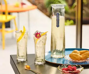 A carafe of St-Germain Elderflower Liqueur with two glasses