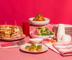 Dishes from O&B against a pink backdrop