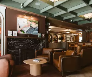 New Toronto restaurants | Comfy chairs and art on the wall at Book Bar Toronto