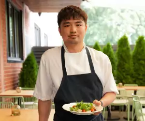 Parquet chef Nicky Dao poses with a dish on the Harbord Street restaurant's patio